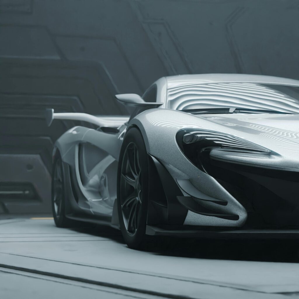 Sleek silver sports car in a high-tech indoor environment, showcasing modern design.