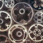 Close-up of interlocking metal gears creating an industrial texture.