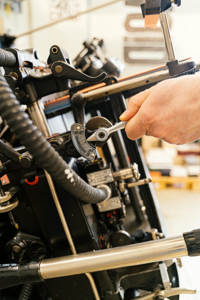 Detailed view of a hand adjusting industrial machinery settings.